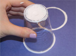 Dip the top of the cup in white paint and press it on the paper.