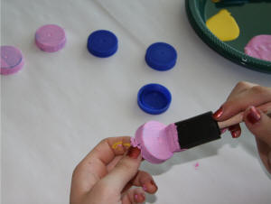Painting the milk carton caps.