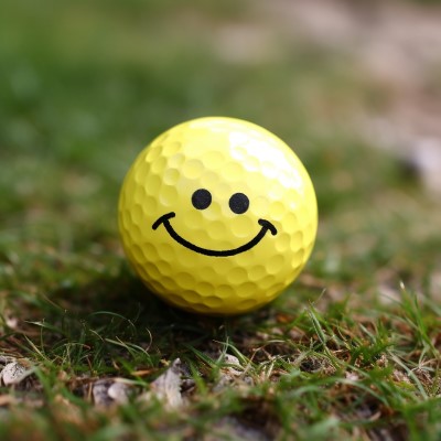 painted smiley face golf ball